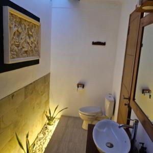 a bathroom with a toilet and a sink at Villa Casablanca Surf Keramas in Keramas