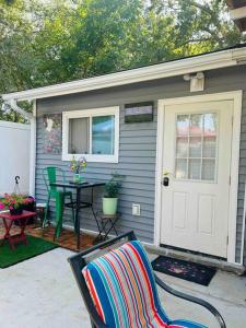 a house with a patio with a table and a door at Fancy studio private entrance in Selden