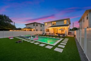 a backyard with a swimming pool and a house at Luxury Home w Heated Pool Gym Playground & More in Tampa