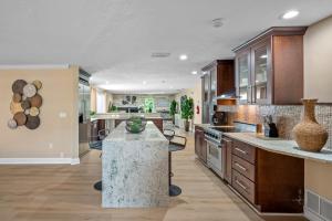 a large kitchen with a island in the middle at Luxury Cristiano Manor 8BR w Pool - 20 Guests in Largo