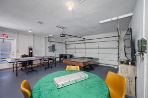 a ping pong room with ping pong tables and chairs at Luxury Cristiano Manor 8BR w Pool - 20 Guests in Largo +91 photos