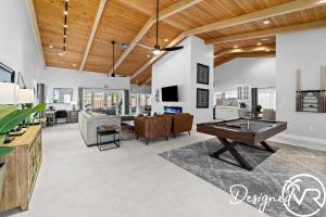 a living room with a ping pong table at Charming 9BR New-Build Home w Heated Pool & Games in Hollywood