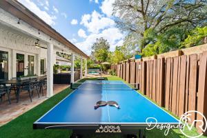 a pool table with a pair of sunglasses on top at Charming 9BR New-Build Home w Heated Pool & Games in Hollywood