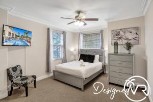 a bedroom with a bed and a ceiling fan at Gorgeous venetian home walk to beach with HOTTUB in Hollywood