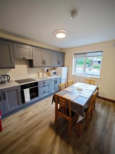 kuchnia ze stołem i krzesłami w kuchni w obiekcie Mountain View Accommodation w mieście Donegal