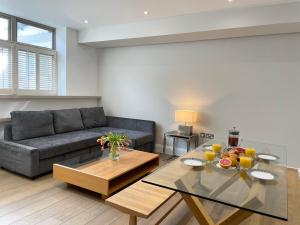 a living room with a couch and a table at Luxury Apartments in Westminster in London