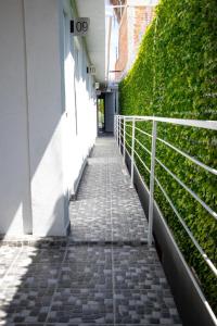 a walkway leading to a building with a green wall at Hotel El Rincón in San Francisco del Rincón +17 photos