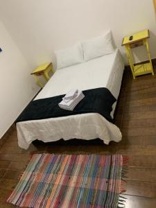 um quarto com uma cama grande e um cobertor preto em Pousada Tabernáculo em Tiradentes