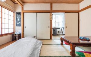 a bedroom with a bed and a table at 板東ビル in Tokyo