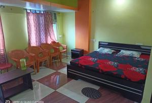 1 dormitorio con 1 cama, mesa y sillas en Hotel M.K. Palace en Gaya