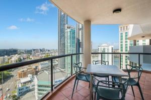 a balcony with a table and chairs and a city at Riverview 2B2B apt in CBD w/parking, pool, gym in Brisbane