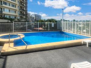 a swimming pool on a balcony of a building at Welcome Homestay Bayside in Larrakeyah