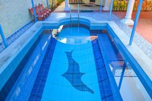 a dolphin stencil in a swimming pool at Panaiyur Guest house in Chennai