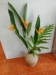a vase with a plant in it on a floor at Tropical Paradise Leelawadee Resort in Ko Chang