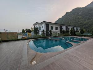 a swimming pool in front of a house at Amazing Views & Eco Friendly Luxury Onsen Suites, Lost World of Tambun in Ipoh +14 photos