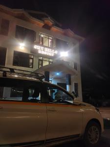 帕哈爾加姆的住宿－SKY HILLS RESORT，夜间停在大楼前的汽车