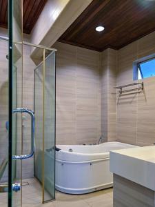 a large bathroom with a tub and a shower at KL Secret Karaoke Private Pool Villa in Ampang