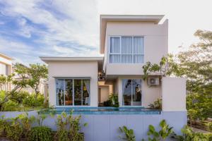 a white house with a pool in front of it at Alveshouse Suite Bali Villa - Nusa Dua in Ungasan