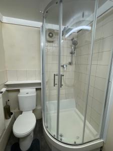 a bathroom with a shower and a toilet at Stay with Light in Ipswich