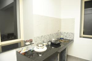 a bathroom with a sink and a counter top at Sai Homestay Panaji 2 BHK and Studio Apartment in Panaji