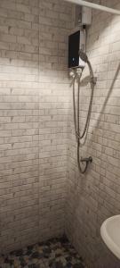 a shower in a white tiled bathroom with a sink at Dorothys in Pattaya South