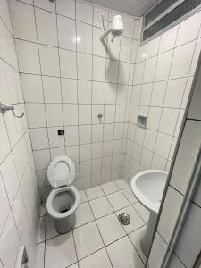 a bathroom with a toilet and a sink at Hotel Karisma II in São Bernardo do Campo