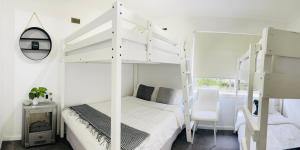 een slaapkamer met een wit stapelbed en een stoel bij D101 Charming Apartment- Free Parking in Melbourne