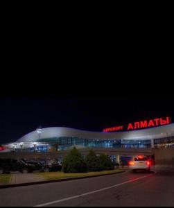 a building with a car driving in front of it at Апартаменты напротив аэропорта in Turksib