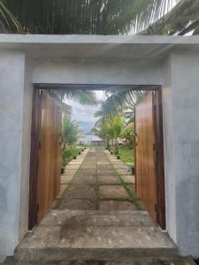 an entrance to a building with two wooden doors at Bruri Villa in Alor-kecil