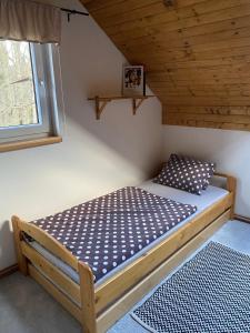 een bed in een kleine kamer met een raam bij Apartman U vleku in Ceske Petrovice