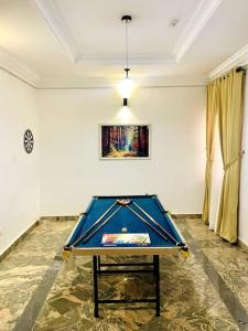 a room with a ping pong table in the middle at Luxury Oasis 1 - Entire 1 Bedroom Apartment in Abuja with Pool, Games, WiFi, Balcony, and Garden in Abuja