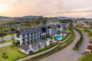 an aerial view of a building with a pool at Bergh Apton Khao Yai in Khao Yai