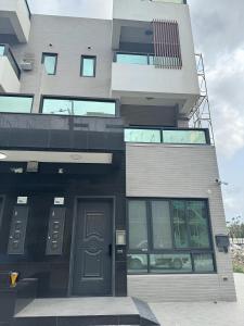 a tall building with a door in front of it at 墾丁包棟民宿-宇樂 in Hengchun