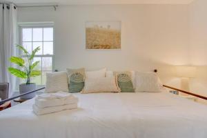 a large white bed in a white room at The Retreat - Private Pool-Spa-Firepit-Gameroom in Greenwood +34 photos