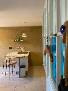 a kitchen with a table and chairs and a refrigerator at City Apartment Markdorf in Markdorf