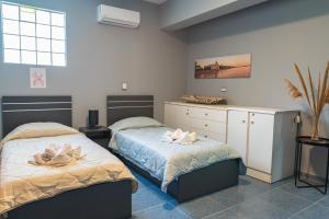 a bedroom with two beds with towels on them at Kos Dream Beachwalk Apartment in Tigaki