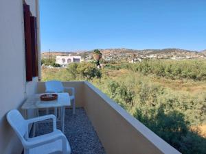 a balcony with a table and chairs and a view at Ioanna's House@Foinikas Syros in Finikas