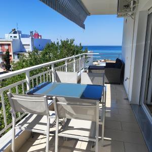 stół i krzesła na balkonie z widokiem na ocean w obiekcie Christina-2 w mieście Perea