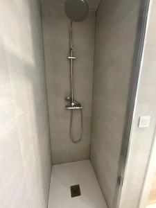 a shower in a white bathroom with a shower at Piso nuevo Almeria Centro in Almería