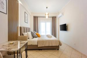 a bedroom with a bed and a table in it at Bingo!!!Studio-5'to Acropolis in Athens