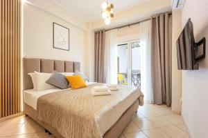 a bedroom with a bed with a television and a balcony at Bingo!!!Studio-5'to Acropolis in Athens