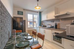 une cuisine avec une table avec des assiettes dessus dans l'établissement Cabana & Miami 70's - Proche Parking et Épicerie, à Mâcon