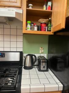 a kitchen counter with a tea kettle on a stove at Suite Sunshine A in Yosemite West