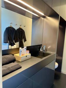 a bathroom with a sink and a mirror at the black line house in Olot