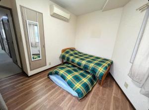 Postel nebo postele na pokoji v ubytování MATUBARA HOUSE