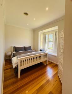 a bedroom with a large bed and a window at Townhouse Near The World’s Coolest High st in 2024 in Melbourne