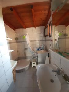 a bathroom with a sink and a tub and a toilet at Leisure house in Nea Kallikrateia