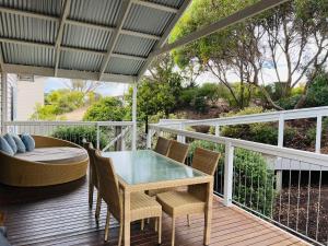 a patio with a table and chairs on a deck at Salt Life - Pet Friendly Outside WIFI in Robe