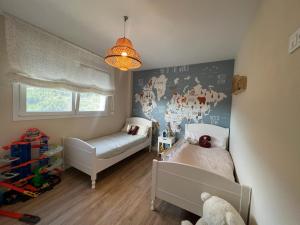 a small room with two beds and a window at Villa Guadalest hills in Guadalest