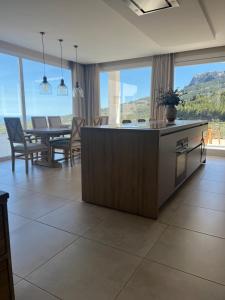 a kitchen and dining room with a table and chairs at Villa Guadalest hills in Guadalest